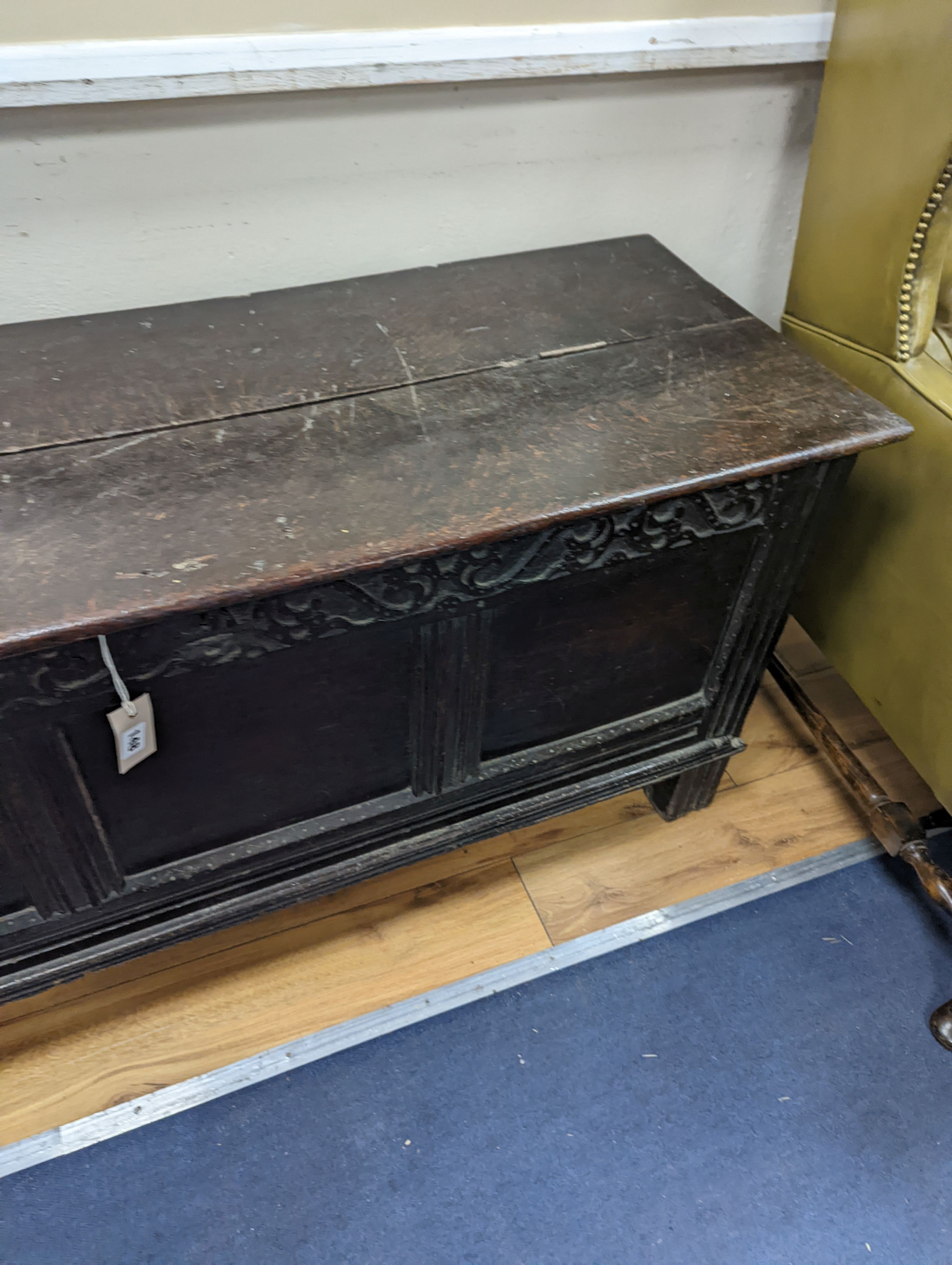 A 17th century panelled oak coffer, (the hinged lid adapted) width 130cm, depth 49cm, height 63cm